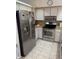 Stainless steel appliances and light tile floor at 310 Blue Jacket Ln, Orlando, FL 32825