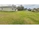 Spacious backyard with green grass and partial view of house at 322 Dagama Ct, Kissimmee, FL 34758