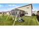 Large backyard with covered patio, swing set, and plenty of grass space at 351 Lazio Cir, Debary, FL 32713