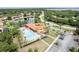 Aerial view of a resort-style community pool and clubhouse with ample parking and landscaping at 351 Lazio Cir, Debary, FL 32713