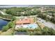 Aerial view of a stunning community pool and clubhouse surrounded by lush landscaping and trees at 351 Lazio Cir, Debary, FL 32713