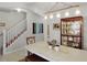 Dining area with a wooden table and access to the kitchen and staircase at 351 Lazio Cir, Debary, FL 32713