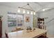 Light-filled dining area with a farmhouse table and access to the kitchen at 351 Lazio Cir, Debary, FL 32713