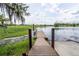 Scenic wooden dock extending into a tranquil lake, ideal for relaxation and enjoying nature at 351 Lazio Cir, Debary, FL 32713
