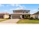 Two-story house with a two-car garage and well-manicured lawn at 351 Lazio Cir, Debary, FL 32713
