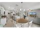 Open kitchen with an island, white cabinets, and a dining area at 351 Lazio Cir, Debary, FL 32713