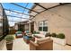 Cozy screened patio with comfortable seating, perfect for relaxing and entertaining outdoors at 351 Lazio Cir, Debary, FL 32713