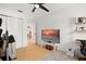 Bright bedroom with hardwood floors and a large TV at 488 W Par St # 4, Orlando, FL 32804
