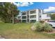 Two-story condo building with green accents and lush landscaping at 488 W Par St # 4, Orlando, FL 32804