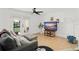 Bright living room with hardwood floors, gray sofa, and large TV at 488 W Par St # 4, Orlando, FL 32804