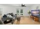 Living room with hardwood floors, gray sofa, and access to a balcony at 488 W Par St # 4, Orlando, FL 32804