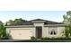 One-story home with light-colored siding, a two-car garage, and landscaping at 5068 Tana Ter, St Cloud, FL 34772