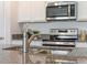 Modern kitchen features stainless steel appliances and granite countertops at 5071 Tana Ter, St Cloud, FL 34772
