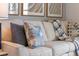 Light beige couch with blue pillows and throw blanket at 5071 Tana Ter, St Cloud, FL 34772