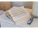 Open book and glasses on a white nightstand at 5072 Tana Ter, St Cloud, FL 34772