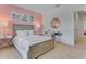 Bedroom with a pink accent wall, full bed, and built-in desk at 5076 Tana Ter, St Cloud, FL 34772