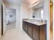 Double vanity bathroom with granite countertop and view of bedroom at 5080 Tana Ter, St Cloud, FL 34772