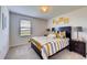 Bedroom with yellow and grey striped bedding and window at 5080 Tana Ter, St Cloud, FL 34772