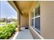 Covered front porch with neutral color scheme and a view of the neighborhood at 5080 Tana Ter, St Cloud, FL 34772