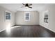 Bright bedroom with hardwood floors and multiple windows at 5703 Se 109Th St, Belleview, FL 34420