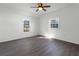 Spacious bedroom with two windows and wood floors at 5703 Se 109Th St, Belleview, FL 34420