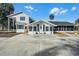 Two-story home featuring a covered porch and a screened patio at 5703 Se 109Th St, Belleview, FL 34420