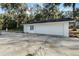 Detached garage with a large door and a window at 5703 Se 109Th St, Belleview, FL 34420