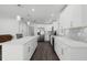 Modern white kitchen with stainless steel appliances and an island at 5703 Se 109Th St, Belleview, FL 34420