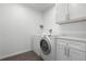 Laundry room with washer, dryer, and cabinets at 5703 Se 109Th St, Belleview, FL 34420