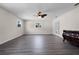 Sunlit living room with hardwood floors and French doors at 5703 Se 109Th St, Belleview, FL 34420