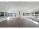 Bright and spacious living room with large windows and wood floors at 5703 Se 109Th St, Belleview, FL 34420