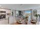 Modern dining area with wooden table, kitchen, and backyard views at 6587 Leo Ln, St Cloud, FL 34773