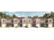 Front view of a charming townhome community with attached garages at 6587 Leo Ln, St Cloud, FL 34773