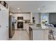 Well-equipped kitchen featuring stainless steel appliances and granite countertops at 6587 Leo Ln, St Cloud, FL 34773