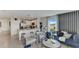 Open concept living room with modern furniture and kitchen access at 6587 Leo Ln, St Cloud, FL 34773