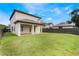 Large backyard with covered patio and grassy area at 675 Overspin Dr, Winter Park, FL 32789