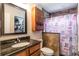Bathroom with granite countertop, dark wood cabinets, and shower at 675 Overspin Dr, Winter Park, FL 32789