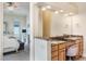 Double vanity bathroom with granite countertops and a view into bedroom at 675 Overspin Dr, Winter Park, FL 32789