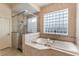 Spa-like bathroom with a large walk-in shower and a soaking tub at 675 Overspin Dr, Winter Park, FL 32789