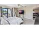 Bright bedroom with a comfortable bed, private balcony and a large TV at 675 Overspin Dr, Winter Park, FL 32789
