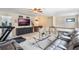 Large bonus room includes a TV, media console, and comfortable seating at 675 Overspin Dr, Winter Park, FL 32789