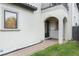 Front entrance with arched entryway and walkway at 675 Overspin Dr, Winter Park, FL 32789