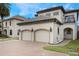 Two-story house with a two-car garage and paved driveway at 675 Overspin Dr, Winter Park, FL 32789