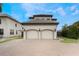 Two-story house with a two-car garage and paved driveway at 675 Overspin Dr, Winter Park, FL 32789