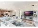 Open living room with sectional sofa and large screen TV at 675 Overspin Dr, Winter Park, FL 32789