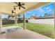 Covered patio with ceiling fans and grassy backyard views at 675 Overspin Dr, Winter Park, FL 32789
