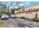 Tan stucco building with three-car garage and landscaping at 711 Centervale Dr # 711, Celebration, FL 34747