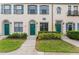 Three-unit townhouse building with green doors and landscaping at 711 Centervale Dr # 711, Celebration, FL 34747