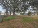Large backyard with mature trees and chain link fence at 770 Mink Ct, Poinciana, FL 34759