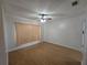 Cozy bedroom with wood floors, ample natural light, and a ceiling fan for added comfort at 770 Mink Ct, Poinciana, FL 34759